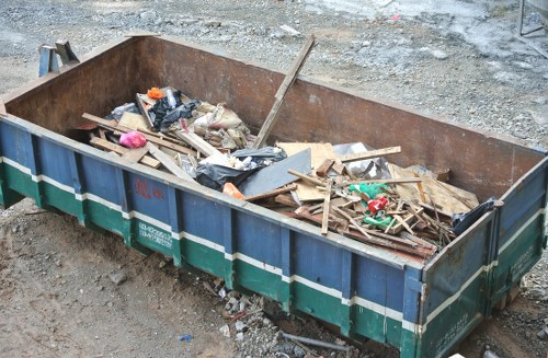 A cluttered garage being cleared by professionals